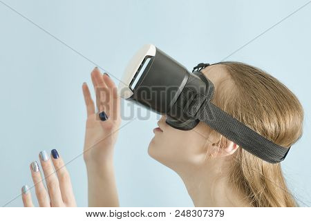 Yuong Woman With Glasses Of Virtual Reality. Blue Background