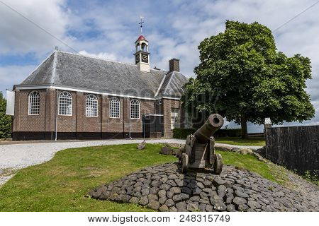 Schokland, Netherlands, June 23, 2018: Church And Cannon Of Former Island Schokland, Unesco World He