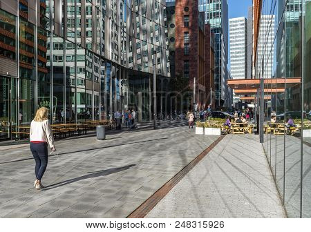Amsterdam, The Netherlands - June 20, 2018: Woman With Smartphone On The Amsterdam Zuidas, Netherlan