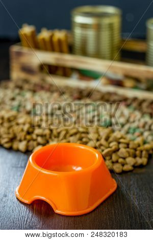 Small Orange Bowl For Pet Food And Dry Food As Background
