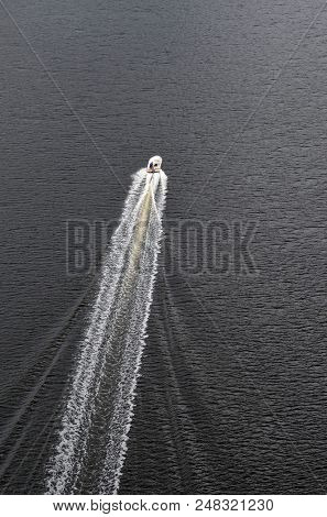 
A motor boat in the fjord goes along the border of Norway and Sweden.June 18,2018.Ostfold Region,Norway