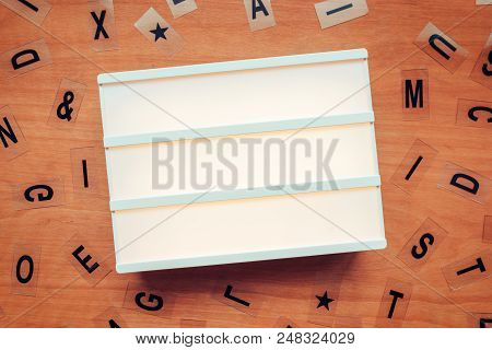 Blank Lightbox And Letters On Wooden Background, Mock Up Copy Space For Text