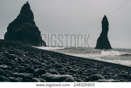 Black Stones With Shoreline And Big Black Rocks In Iceland
