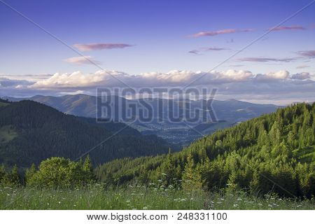 Photo Of Mountain Landscape In The Summer Under Beautiful Cloudy Sky. Ukraine, Carpathians, Dzembron
