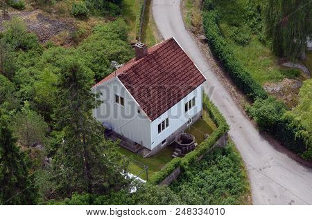 Typical Norwegian nature and houses on the shore of the fjord. View from the high bridge over the fjord. The border of Norway and Sweden.June 18,2018.Near the town Selater,Sweden