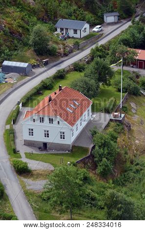 Typical Swedish nature and houses on the shore of the fjord. View from the high bridge over the fjord. The border of Norway and Sweden.June 18,2018.Near the town Selater,Sweden