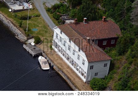 Typical Norwegian nature and houses on the shore of the fjord. View from the high bridge over the fjord. The border of Norway and Sweden.June 18,2018.Near the town Selater,Sweden