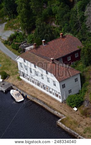 Typical Norwegian nature and houses on the shore of the fjord. View from the high bridge over the fjord. The border of Norway and Sweden.June 18,2018.Near the town Selater,Sweden