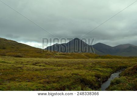Stunning Landscape With Fields, A Stream And A Large Mountain