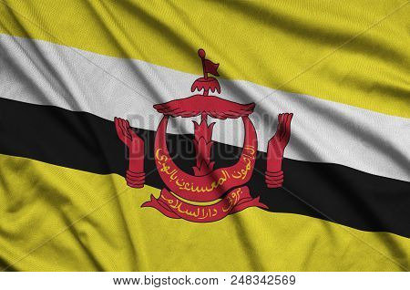 Brunei Darussalam Flag  Is Depicted On A Sports Cloth Fabric With Many Folds. Sport Team Waving Bann