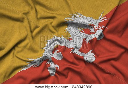 Bhutan Flag  Is Depicted On A Sports Cloth Fabric With Many Folds. Sport Team Waving Banner