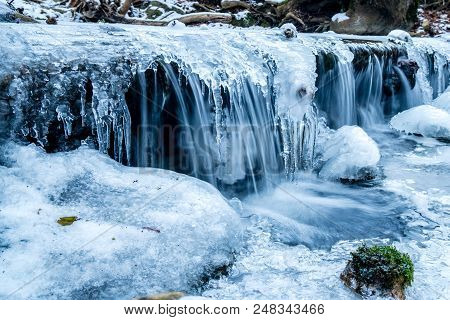 Frozen Stream Little Waterfall With Moss Closeup