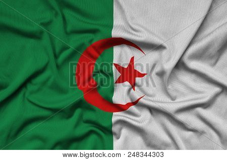 Algeria Flag  Is Depicted On A Sports Cloth Fabric With Many Folds. Sport Team Waving Banner