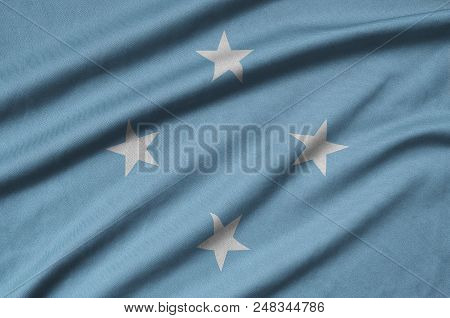 Micronesia Flag  Is Depicted On A Sports Cloth Fabric With Many Folds. Sport Team Waving Banner