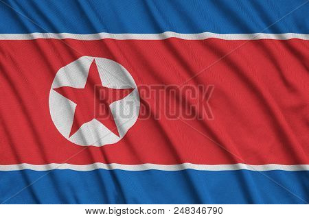 North Korea Flag  Is Depicted On A Sports Cloth Fabric With Many Folds. Sport Team Waving Banner