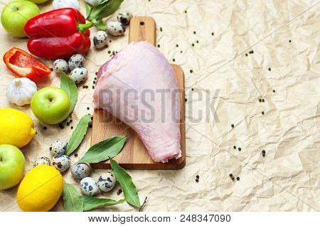 Raw Turkey Thigh Garlic Apples Lemon Red Bell Pepper Quail Eggs Spices On A Wooden Board. Top View O