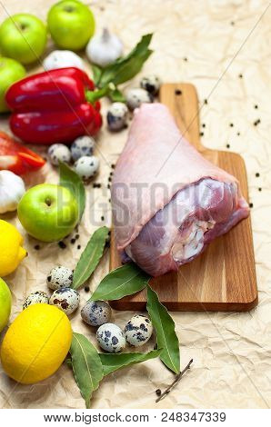 Raw Turkey Thigh Garlic Apples Lemon Red Bell Pepper Quail Eggs Spices On A Wooden Board. Top View O