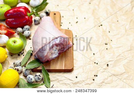 Raw Turkey Thigh Garlic Apples Lemon Red Bell Pepper Quail Eggs Spices On A Wooden Board. Top View O