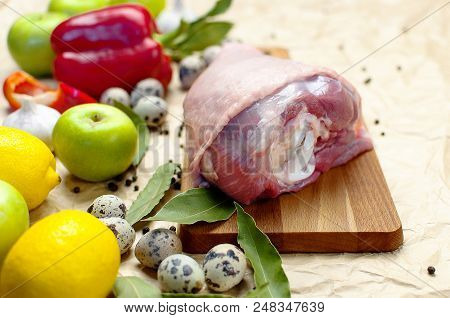 Raw Turkey Thigh Garlic Apples Lemon Red Bell Pepper Quail Eggs Spices On A Wooden Board. Top View O