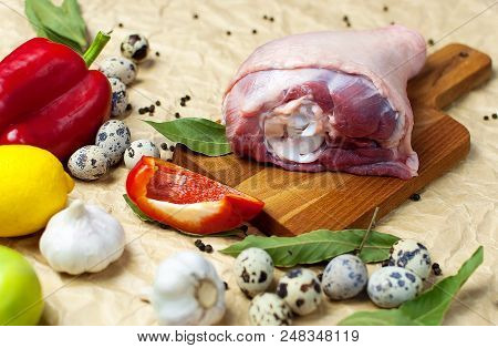 Raw Turkey Thigh Garlic Apples Lemon Red Bell Pepper Quail Eggs Spices On A Wooden Board. Top View O