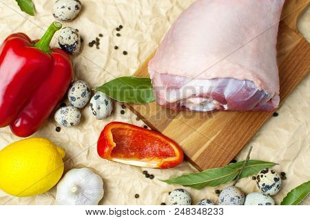 Raw Turkey Thigh Garlic Apples Lemon Red Bell Pepper Quail Eggs Spices On A Wooden Board. Top View O