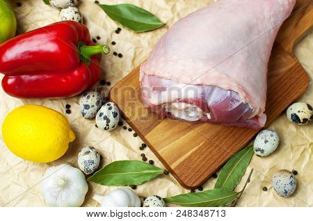 Raw Turkey Thigh Garlic Apples Lemon Red Bell Pepper Quail Eggs Spices On A Wooden Board. Top View O