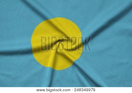 Palau Flag  Is Depicted On A Sports Cloth Fabric With Many Folds. Sport Team Waving Banner