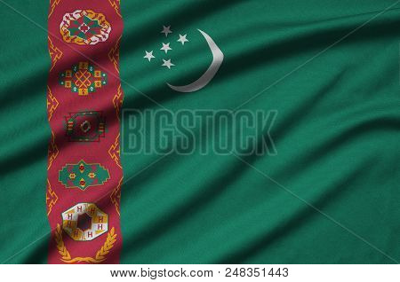 Turkmenistan Flag  Is Depicted On A Sports Cloth Fabric With Many Folds. Sport Team Waving Banner