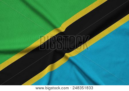 Tanzania Flag  Is Depicted On A Sports Cloth Fabric With Many Folds. Sport Team Waving Banner