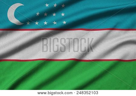 Uzbekistan Flag  Is Depicted On A Sports Cloth Fabric With Many Folds. Sport Team Waving Banner