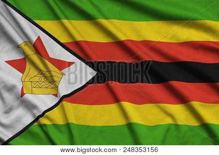 Zimbabwe Flag  Is Depicted On A Sports Cloth Fabric With Many Folds. Sport Team Waving Banner
