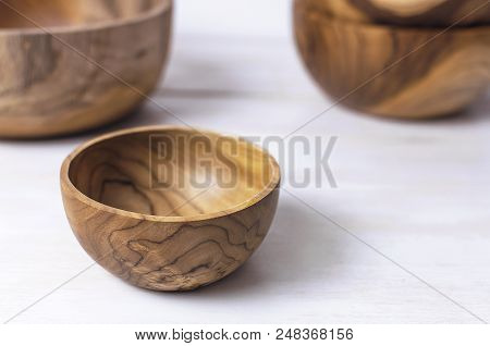 Wooden Utensils For The Kitchen, Bowls, Plates On A Light Background. The Concept Of Natural Dishes,