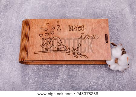 A Carved Wooden Casket With Cute Images Is Decorated With Pussy-willow, Lying On The Grey Background