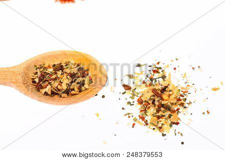 Spoon Filled With Mix Of Kitchen Herbs. Spoon Full Of Mix Of Kitchen Herbs On White Background, Clos