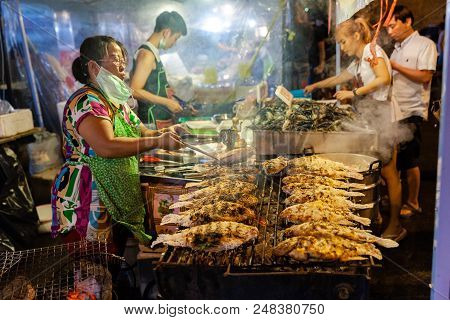 Chiang Mai, Thailand - August 27: Food Vendor Cooks Fish At The Saturday Night Market (walking Stree
