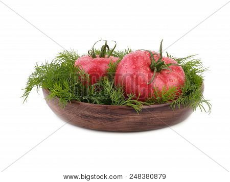 Ripe Tomatoes With Fresh Dill Are Arranged On The Rural Wooden Plate, Situated On The White Backgrou