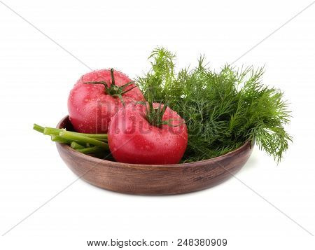 Ripe Tomatoes With Fresh Dill Are Arranged On The Rural Wooden Plate, Situated On The White Backgrou