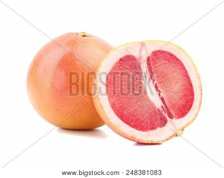 Ripe Grapefruit With Its Fragrant Red Slices Is Situated On The White Background.