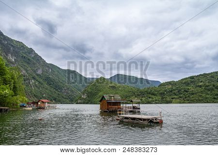 Fishemen Floating Houses On Perucac Lake, On The Drina River, In Western Serbia, Surrounded By A Val