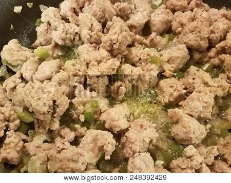 Seasoned Ground Turkey Meat Sizzing In A Frying Pan With Green Peppers