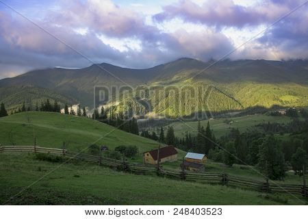 Photo Of Mountain Village In The Summer Under Beautiful Cloudy Sky. Ukraine, Carpathians, Dzembronia