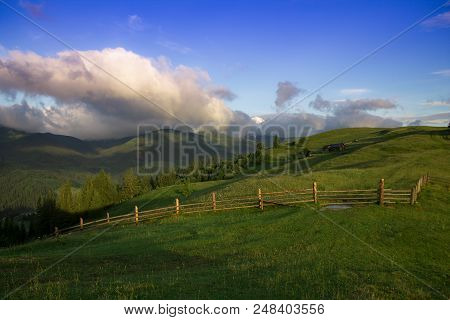 Photo Of Kolyba In Mountain Village In The Summer Under Beautiful Cloudy Sky. Ukraine, Carpathians, 