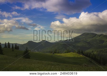 Photo Of Mountain Landscape In The Summer Under Beautiful Cloudy Sky. Ukraine, Carpathians, Dzembron