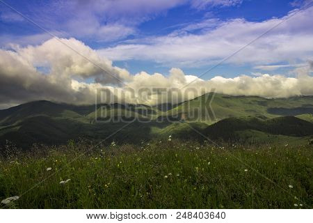 Photo Of Mountain Landscape In The Summer Under Beautiful Cloudy Sky. Ukraine, Carpathians, Dzembron
