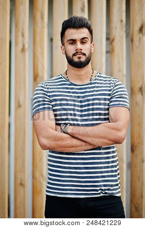 Handsome Tall Arabian Beard Man Model At Stripped Shirt Posed Outdoor Against Wooden Background. Fas