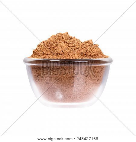 Nutmeg Powder In Glassy Saucepan On White Background. High Resolution Photo.