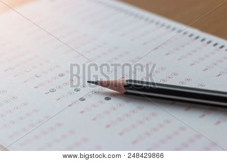 Black Pencil On Paper Computer Sheet. Standardized Test Form With Answers Bubble. Multiple Choice An