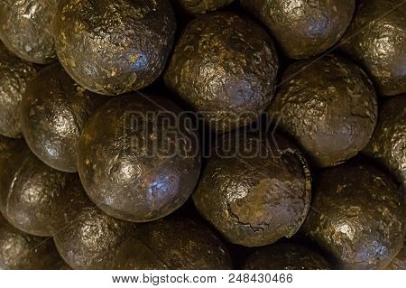 Set Of Cannonballs Black Dark Weather-beaten Metal Balls Close-up Background Design Of Medieval Desi