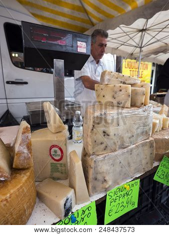 Briancon, France, 10 July 2018: Cheese And Vendor On Market In Briancon In The French Alps Of Haute 