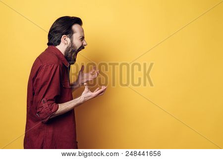 Portrait Of Screaming Frustrated Angry Man. Guy Hands Up And Screaming. Furious Guy With Hipster Hai